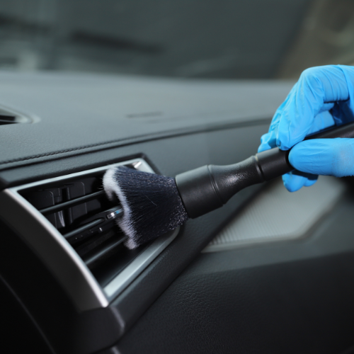 Cleaning car interior with brush